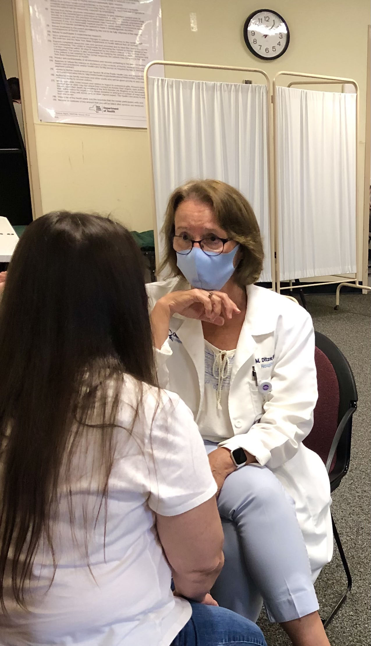 Retired Physician’s Assistant Mary Ditzer is this week’s honoree. She is pictured here talking to a patient at a COVID-19 vaccination clinic at the Oswego County Health Department clinic in Oswego.